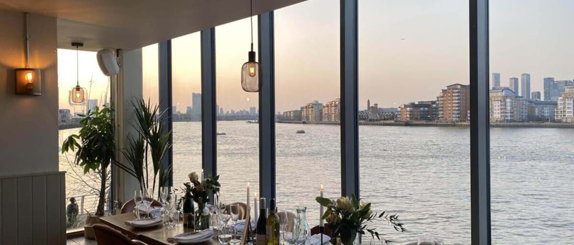 Interior of The Oystercatcher with the view over the Thames