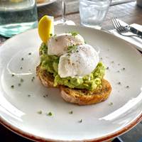 Poached eggs and smashed avocado on toast