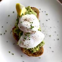 Smashed avocado & poached eggs on sourdough at The Running Horse