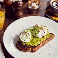 Smashed avocado & poached eggs on sourdough at The Running Horse